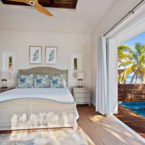 bedroom with private pool in ray caye resort with oceanfront view